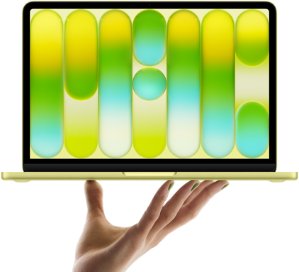 開いた手の指先がシトラスのMacBook Neoをバランス良く支えている。画面にはカラフルで抽象的なパターンが表示されている